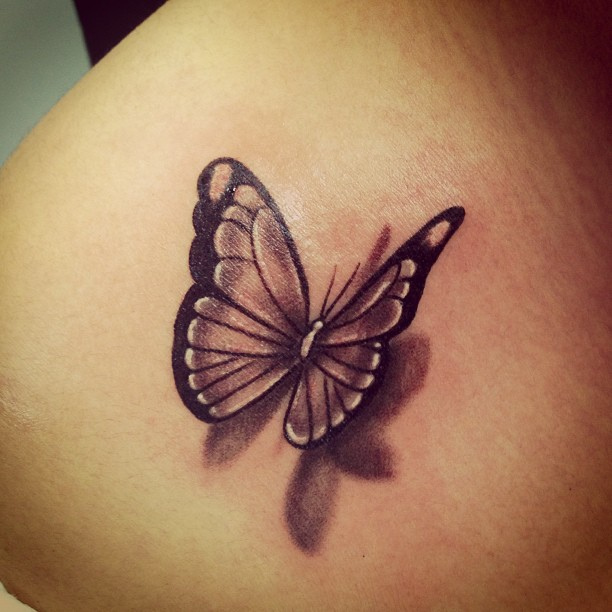 Black and grey flying butterfly tattoo