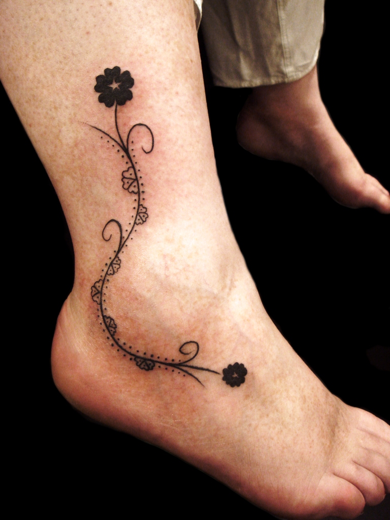 small-black-flowers-ankle-tattoo