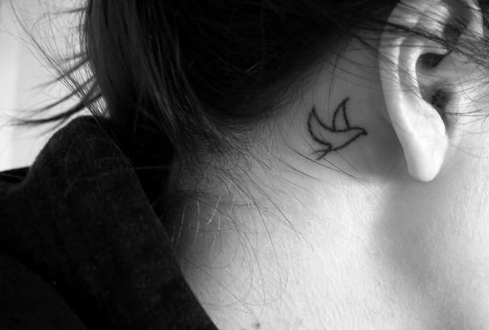 Black-Outline-Bird-Tattoo-On-Girl-Behind-The-Ear