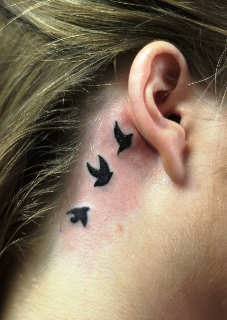 flying-black-birds-back-ear-tattoo