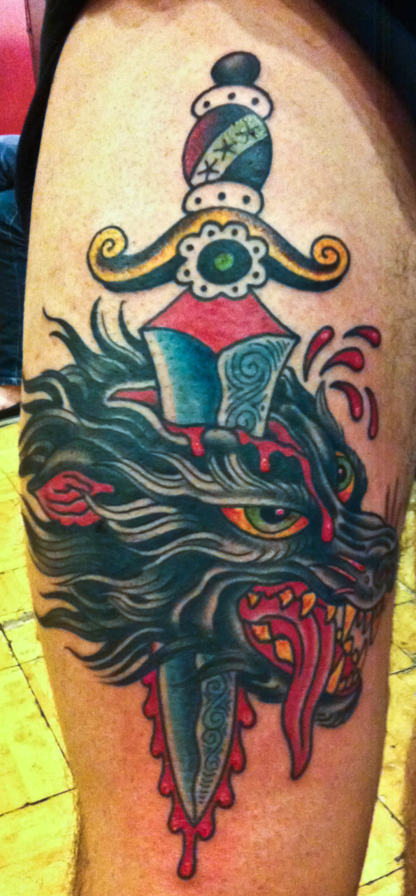 traditional-wolf-head-with-dagger-tattoo
